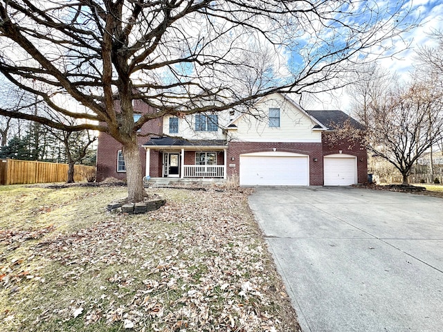 traditional-style house with covered porch, brick siding, fence, and driveway