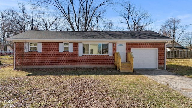 ranch-style home with driveway, brick siding, an attached garage, and fence