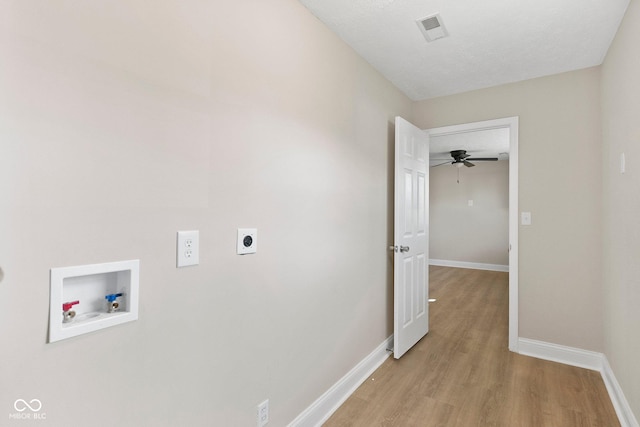 clothes washing area with laundry area, visible vents, light wood-style flooring, washer hookup, and electric dryer hookup