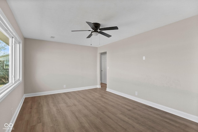 unfurnished room featuring ceiling fan, a textured ceiling, wood finished floors, and baseboards