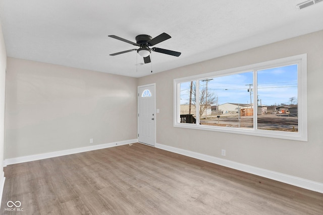 entrance foyer featuring ceiling fan, wood finished floors, visible vents, and baseboards