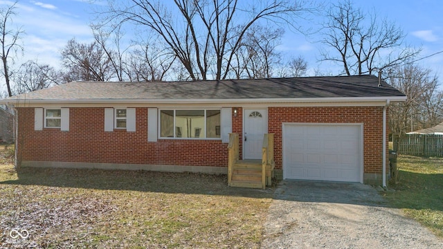 ranch-style house with a garage, driveway, and brick siding