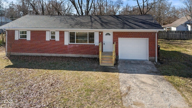 ranch-style home featuring brick siding, concrete driveway, an attached garage, fence, and a front lawn