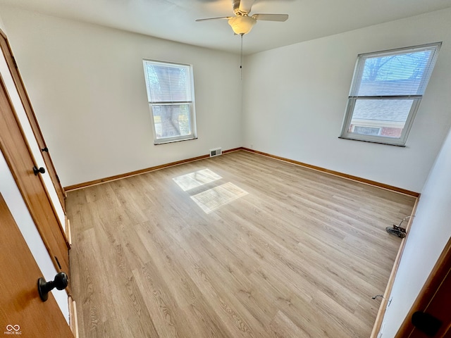 unfurnished bedroom with light wood-style floors, visible vents, baseboards, and ceiling fan