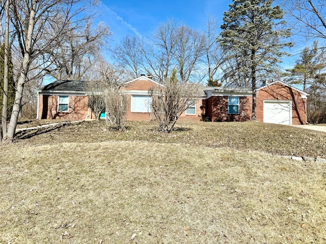 ranch-style home with brick siding, driveway, and an attached garage