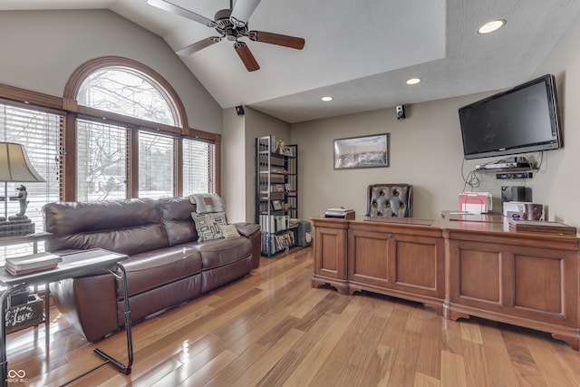 interior space with a ceiling fan, lofted ceiling, a textured ceiling, light wood-type flooring, and recessed lighting