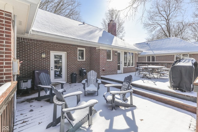 snow covered patio with grilling area