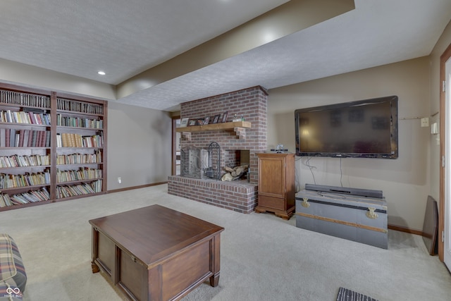 carpeted living area featuring a textured ceiling, recessed lighting, a fireplace, and baseboards