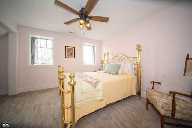 bedroom with carpet floors, visible vents, baseboards, and a ceiling fan