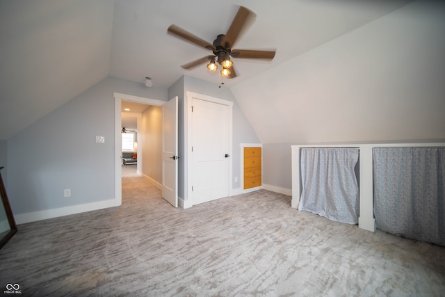 bonus room with lofted ceiling, carpet floors, a ceiling fan, and baseboards