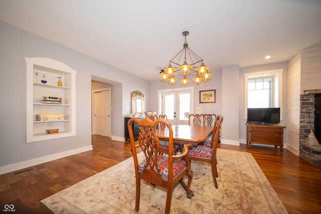 dining space featuring french doors, wood finished floors, visible vents, and a healthy amount of sunlight