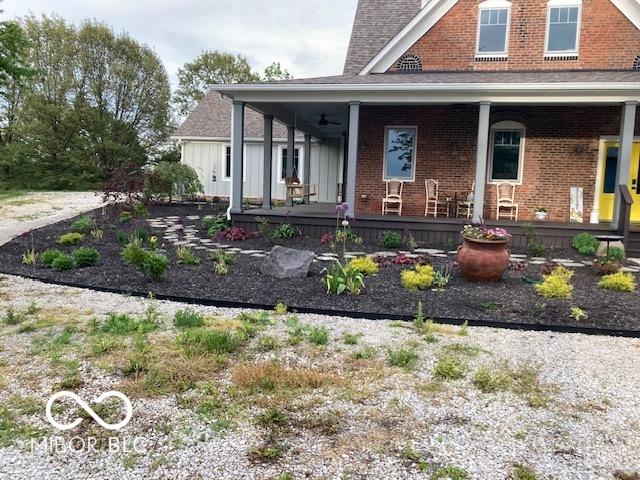 view of front of home with a porch and brick siding