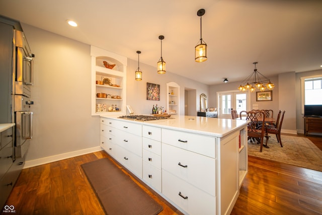 kitchen with oven, a peninsula, open shelves, dark wood finished floors, and stainless steel gas stovetop