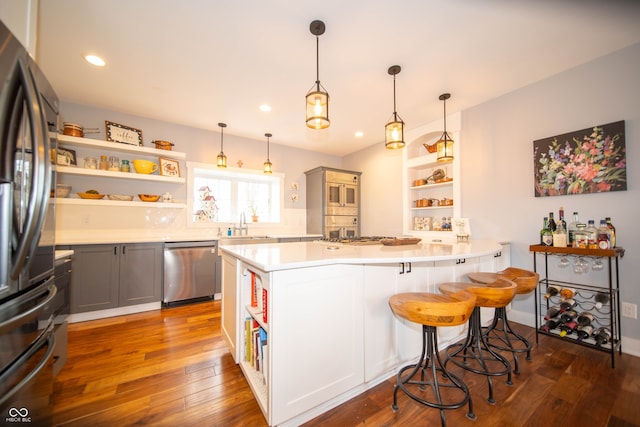 kitchen featuring wood-type flooring, open shelves, dishwasher, and freestanding refrigerator