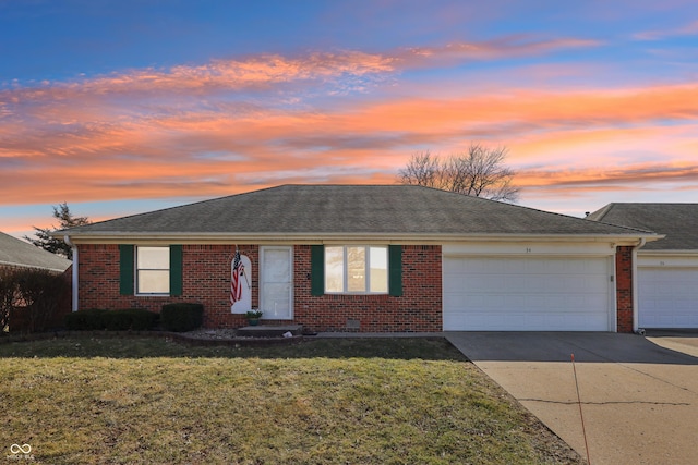 ranch-style home with a front lawn, an attached garage, brick siding, and concrete driveway