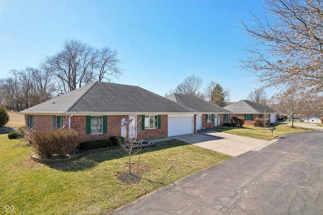 ranch-style home with driveway, an attached garage, a shingled roof, a front lawn, and brick siding