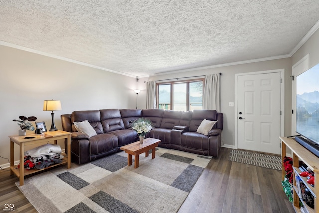 living area with a textured ceiling, crown molding, baseboards, and wood finished floors