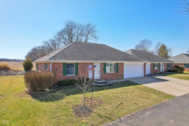 ranch-style home featuring brick siding, a front yard, an attached garage, and driveway