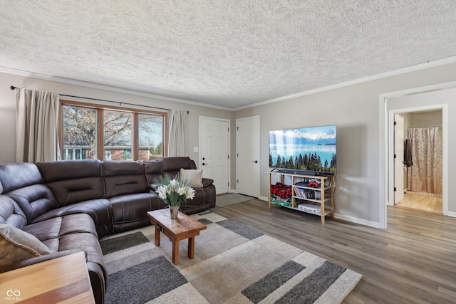 living room with baseboards, a textured ceiling, wood finished floors, and ornamental molding