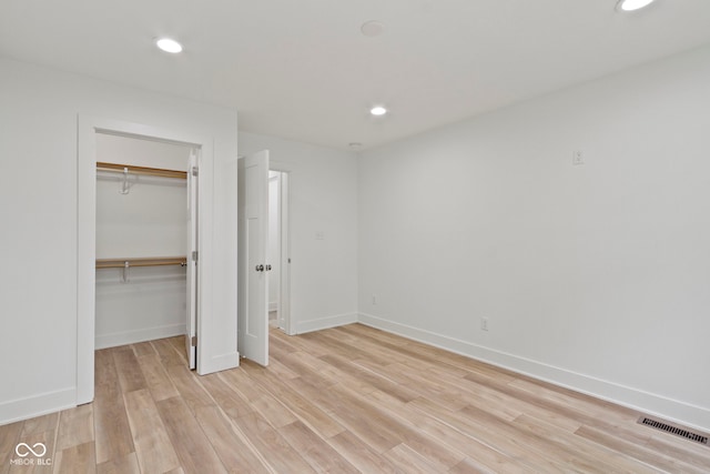 unfurnished bedroom with light wood-type flooring, visible vents, baseboards, and recessed lighting