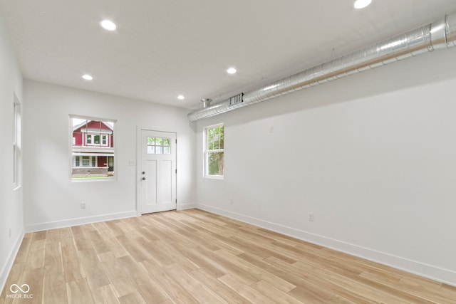 empty room featuring recessed lighting, light wood-style floors, and baseboards