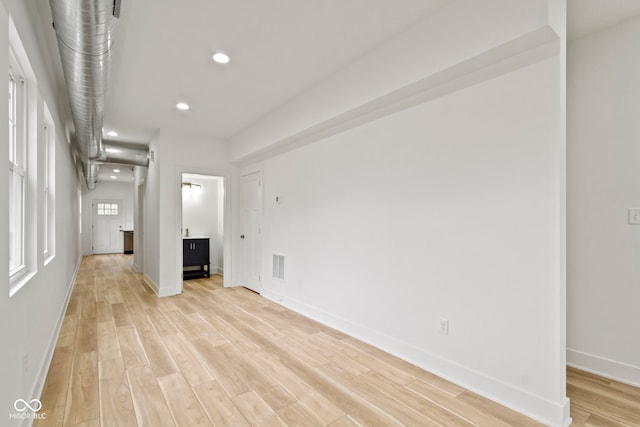 unfurnished room featuring recessed lighting, visible vents, baseboards, and light wood finished floors