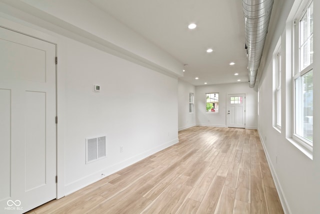 unfurnished living room featuring recessed lighting, baseboards, visible vents, and light wood-type flooring