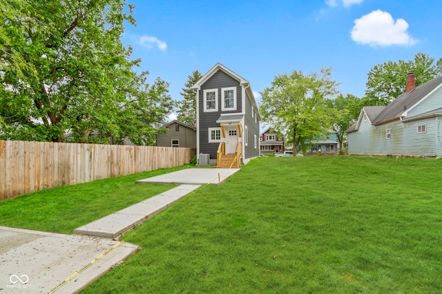 exterior space with entry steps, a yard, and fence