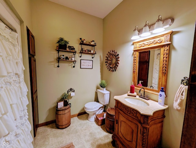 full bath featuring toilet, baseboards, and vanity