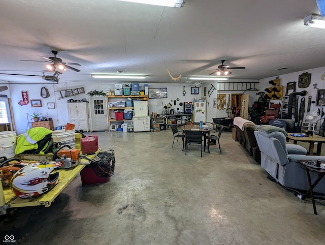 garage featuring ceiling fan and a workshop area