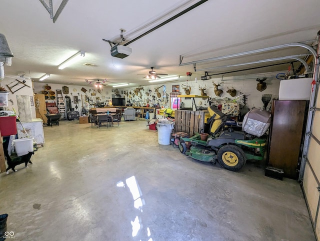 garage featuring ceiling fan, a workshop area, and a garage door opener