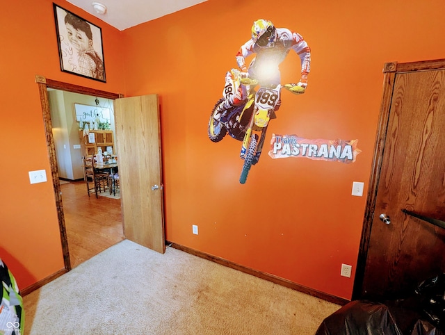 interior space featuring carpet floors and baseboards