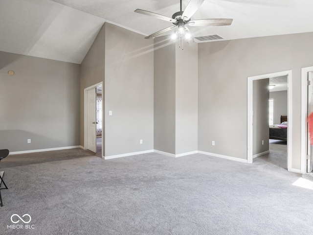 unfurnished bedroom featuring visible vents, baseboards, a ceiling fan, carpet, and high vaulted ceiling