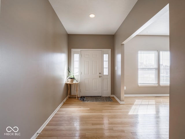 entrance foyer featuring light wood-style flooring, visible vents, and baseboards