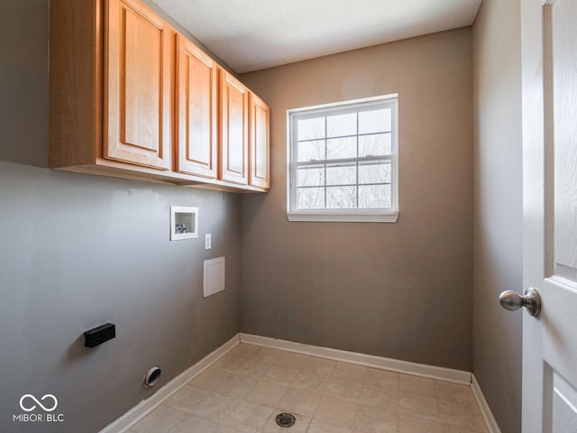 clothes washing area featuring washer hookup, cabinet space, and baseboards