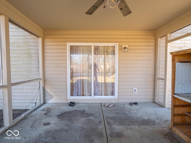 unfurnished sunroom featuring a ceiling fan