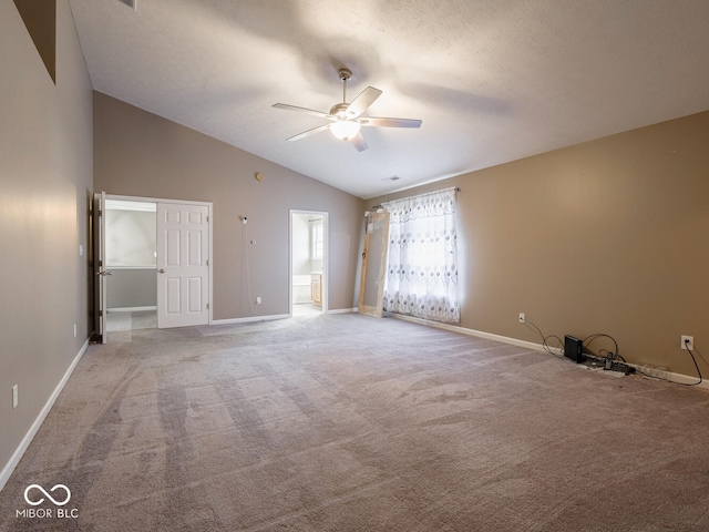 unfurnished bedroom featuring a textured ceiling, ensuite bathroom, light carpet, a ceiling fan, and baseboards