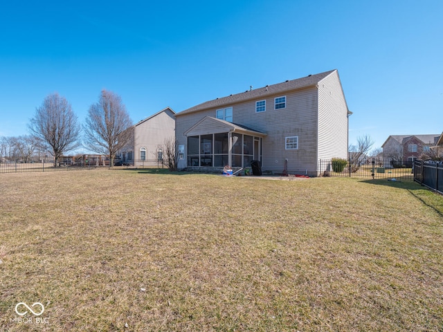 back of house with a yard, a fenced backyard, and a sunroom