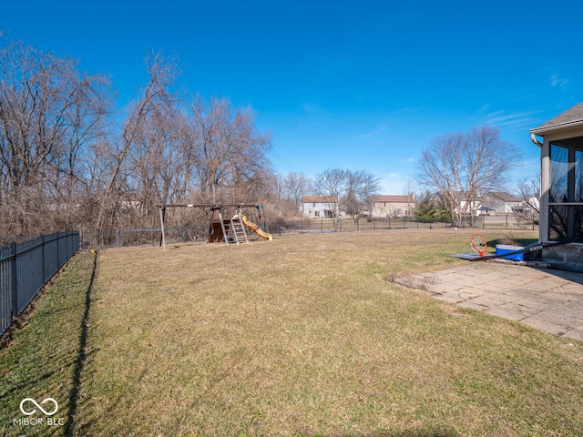 view of yard with a playground, a patio, and a fenced backyard