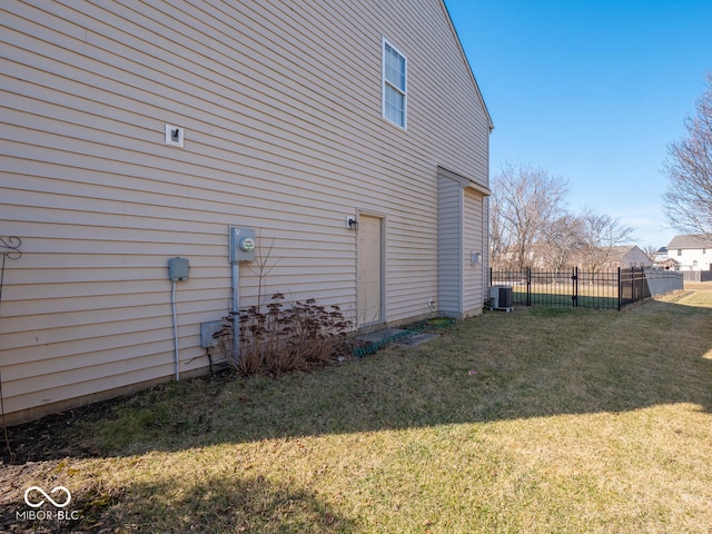 view of home's exterior with a yard and fence