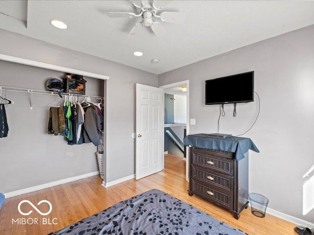 bedroom featuring baseboards, recessed lighting, wood finished floors, a closet, and a ceiling fan