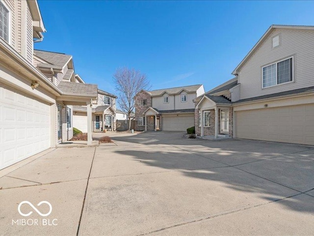 exterior space featuring a residential view, driveway, and a garage