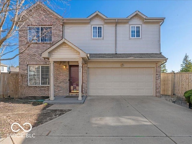 traditional home with brick siding, concrete driveway, an attached garage, and fence