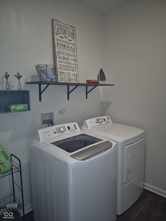 laundry area with laundry area, separate washer and dryer, dark wood-style flooring, and baseboards