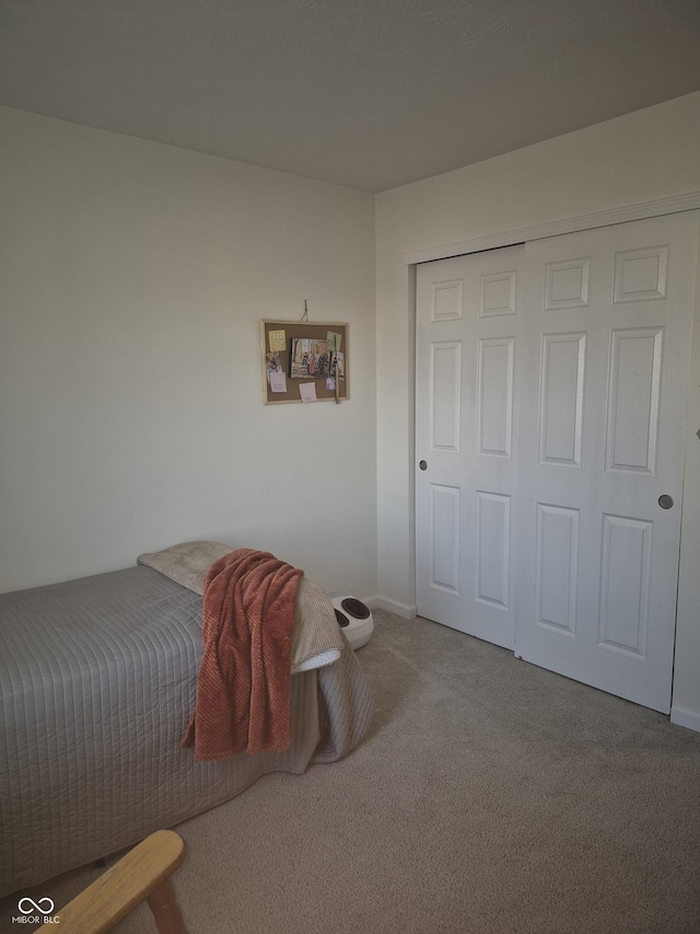 carpeted bedroom with a closet