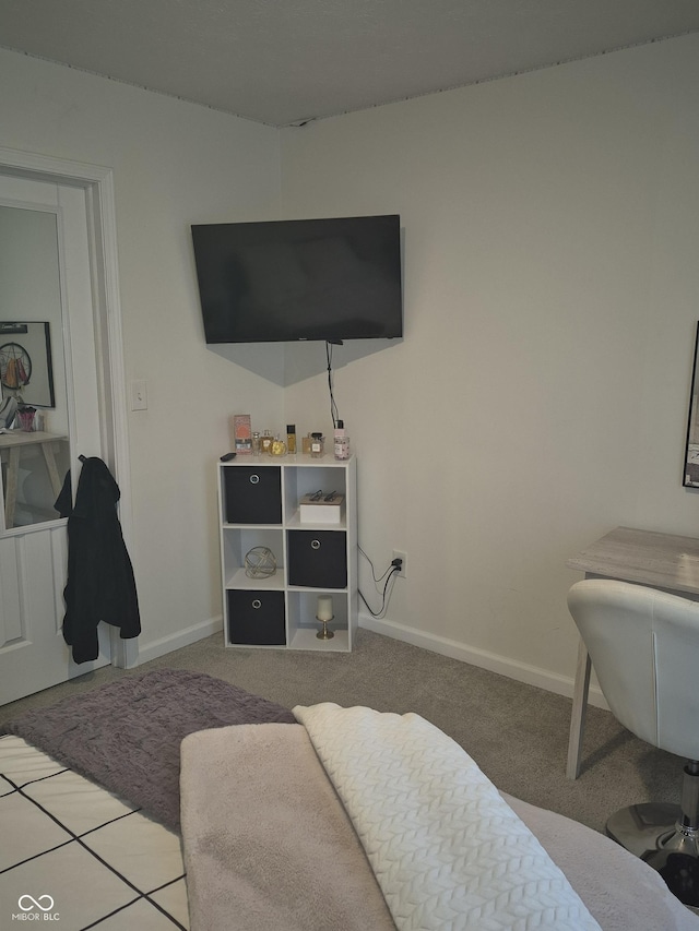 bedroom featuring carpet and baseboards