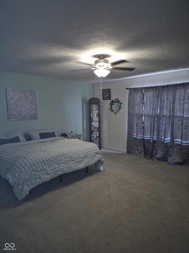 bedroom with carpet, a textured ceiling, and a ceiling fan