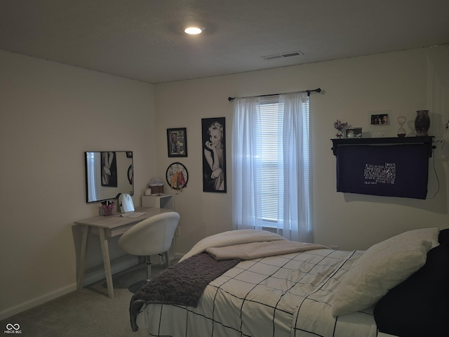 carpeted bedroom with baseboards and visible vents