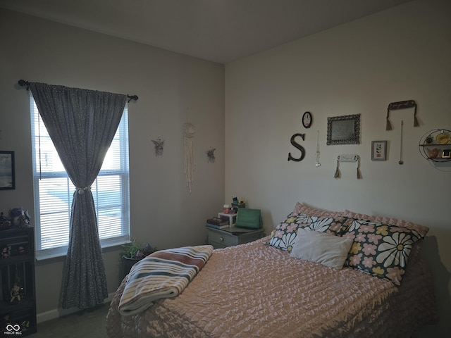 bedroom with carpet and baseboards