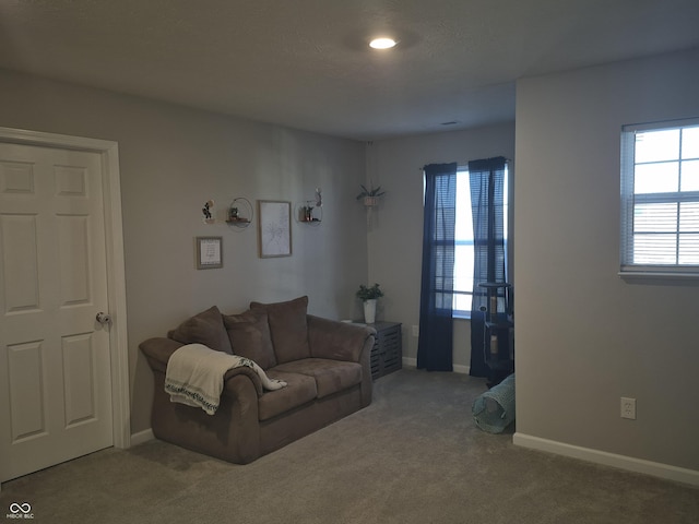 carpeted living room with baseboards